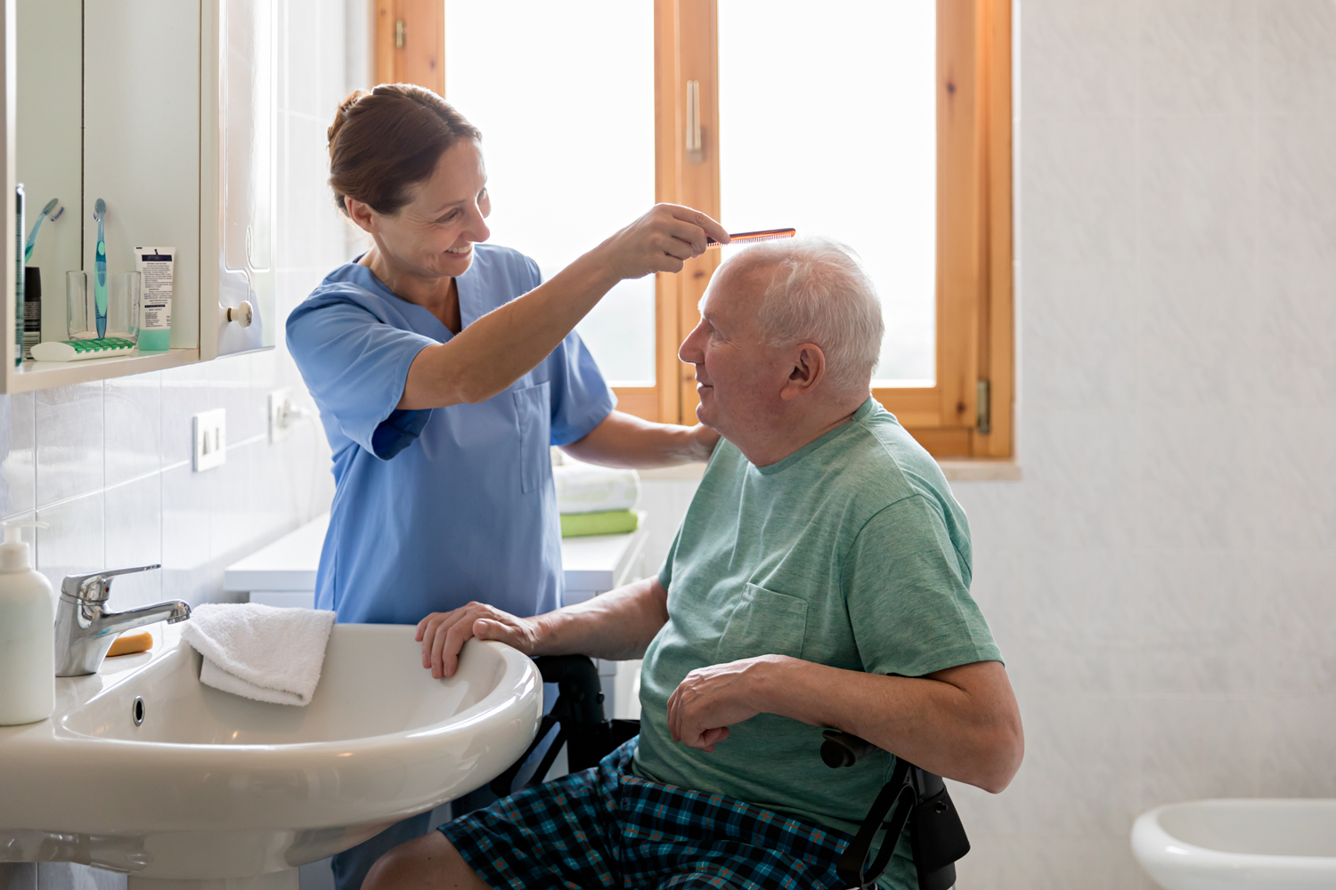 Senior getting hair combed